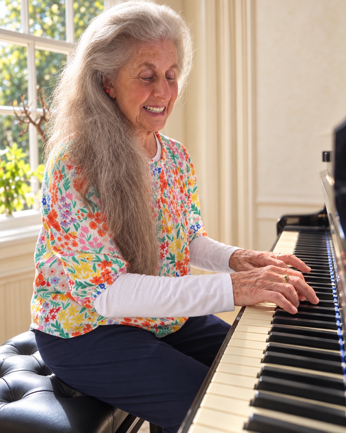 Jocelyn playing the piano in her Henley studio